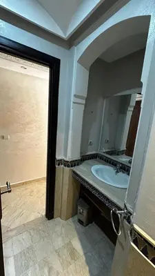 a bathroom with a sink and a large mirror at Luxury & Cozy Apt in Hivernage in Marrakech