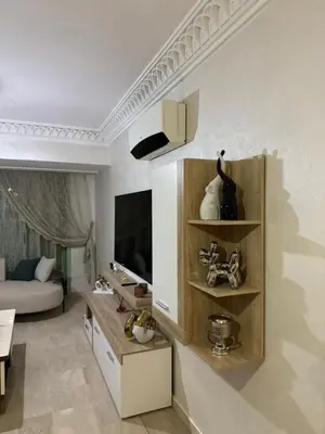 a living room with a couch and a tv at Luxury & Cozy Apt in Hivernage in Marrakech