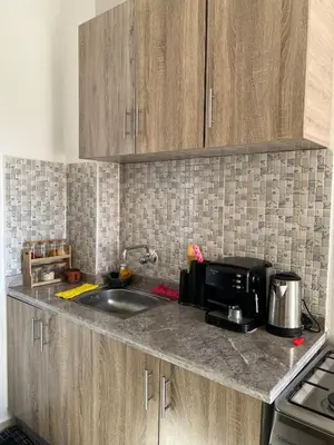 a kitchen counter with a sink and a microwave at Peaceful Marrakech Stay Cozy Well Located in Marrakech