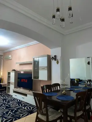 a dining room with a table and chairs and a tv at Elegant apartment in the heart of Gueliz in Marrakech