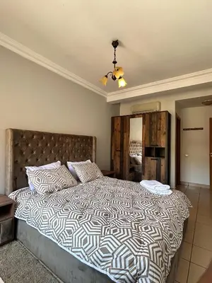 a bedroom with a large bed and a mirror at Elegant apartment in the heart of Gueliz in Marrakech