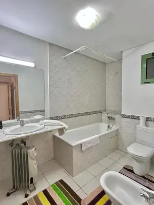 a bathroom with a tub and a toilet and a sink at Elegant apartment in the heart of Gueliz in Marrakech