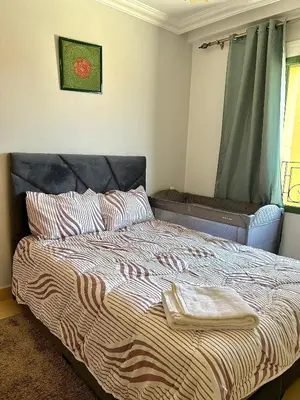a bedroom with a bed with a towel on it at Elegant apartment in the heart of Gueliz in Marrakech