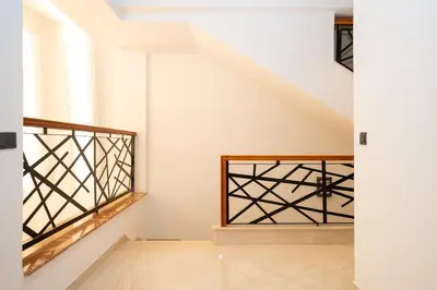a staircase in a house with white walls and a window at Villa Meraki in Marrakech