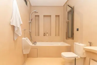 a bathroom with a tub and a toilet and a sink at Villa Meraki in Marrakech