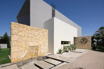a building with a clock on the side of it at Villa Tiaré Luxury, pool, staff and private cinema in Marrakech