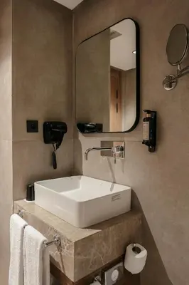a bathroom with a white sink and a mirror at NearYo Hotels in Marrakech