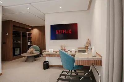 an office with a reception desk and a netflix sign on the wall at NearYo Hotels in Marrakech
