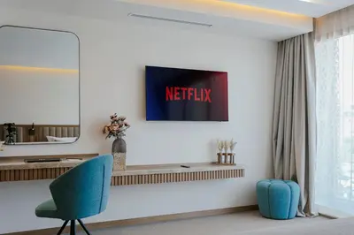 a living room with a desk and a blue chair at NearYo Hotels in Marrakech