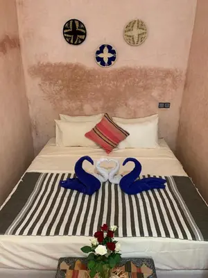 a bed with two blue ribbons on top of it at Riad Zifamo in Marrakech