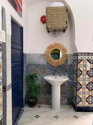 a bathroom with a sink and a mirror at Riad Zifamo in Marrakech