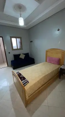 a bedroom with a large bed and a couch at Marrakech,Massira1 in Marrakech