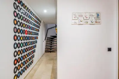 a hallway with a wall covered in colorful objects at Marrakech Duplex Haut Standing, Piscine et Jardin Privé in Marrakech