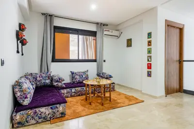 a living room with a couch and a table at Marrakech Duplex Haut Standing, Piscine et Jardin Privé in Marrakech