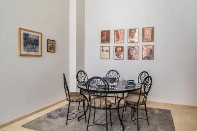 a dining room with a table and four chairs at Marrakech Duplex Haut Standing, Piscine et Jardin Privé in Marrakech