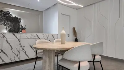 a dining room table with chairs and a vase on it at Duplex Cheryn Heated rooftop pool in Marrakech