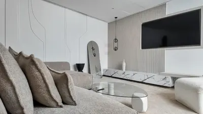 a living room with a couch and a tv at Duplex Cheryn Heated rooftop pool in Marrakech