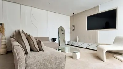a living room with a couch and a tv at Duplex Cheryn Heated rooftop pool in Marrakech