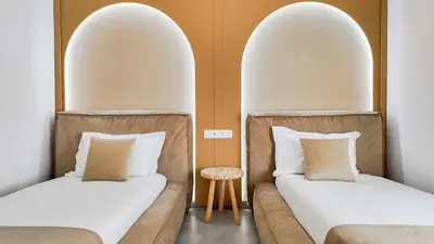 two beds in a room with two archways at Duplex Cheryn Heated rooftop pool in Marrakech