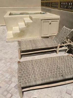a couple of chairs and a table and a sink at Riad MAGE Marrakech in Marrakech