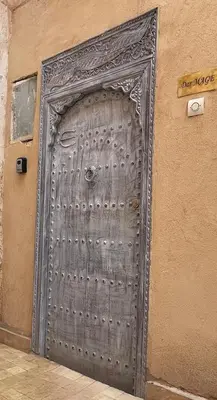 a metal door on the side of a building at Riad MAGE Marrakech in Marrakech