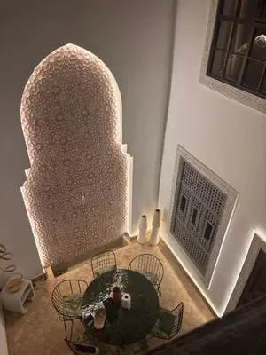an overhead view of a dining room with a table and chairs at Riad MAGE Marrakech in Marrakech
