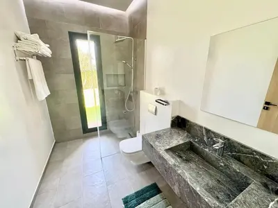 a bathroom with a sink and a toilet and a shower at Villa exclusive Ourika piscine sans vis-à-vis in Segraga