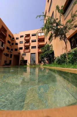 an empty swimming pool in front of a building at 2 Bedroom flat - Marrakech in Marrakech