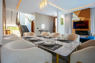 a dining room with a long table and chairs at Villa Aria Marrakech in Marrakech