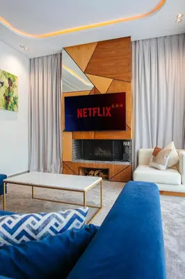 a living room with a television and a couch at Villa Aria Marrakech in Marrakech