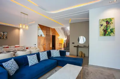 a living room with a blue couch and a table at Villa Aria Marrakech in Marrakech