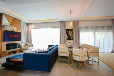 a living room with a blue couch and a table at Villa Aria Marrakech in Marrakech