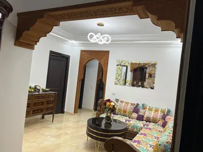 a living room with a couch and a table at Super apt plein centre de Gueliz hyper bien placer pour votre séjour tout à proximité resto café transport in Marrakech