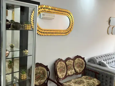 a living room with two chairs and a mirror at Super apt plein centre de Gueliz hyper bien placer pour votre séjour tout à proximité resto café transport in Marrakech