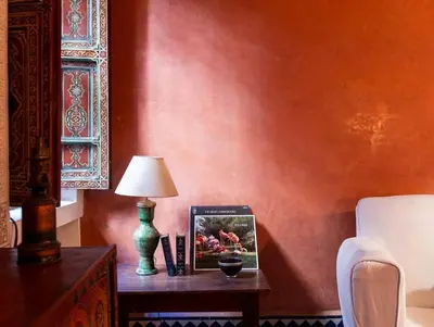a table with a lamp and a picture on it at Riad Bleu-Azrak in Marrakech