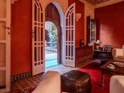 an open door into a living room with a couch at Riad Bleu-Azrak in Marrakech