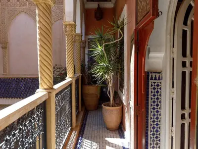 a balcony with potted plants on a building at Riad Bleu-Azrak in Marrakech