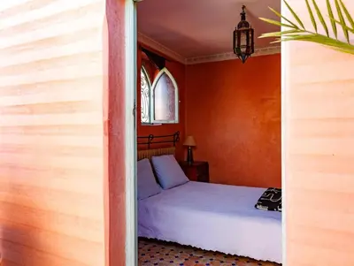 a bedroom with a bed and a window at Riad Bleu-Azrak in Marrakech