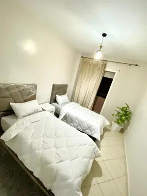 a bedroom with two beds and a window at Bright Modern Apartment Marrakech City Center, Walk Everywhere in Marrakech