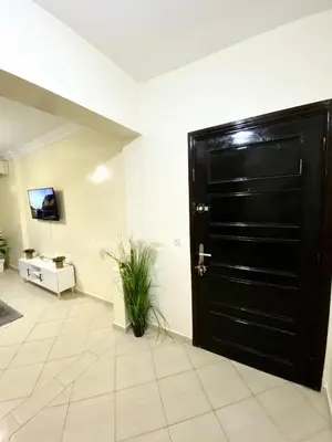 a black door in a room with a tile floor at Bright Modern Apartment Marrakech City Center, Walk Everywhere in Marrakech