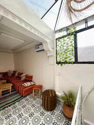 a living room with a couch and a window at Dar Salomi in Marrakech