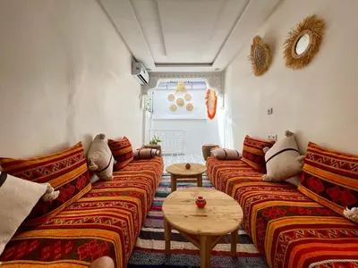a living room with two couches and a table at Dar Salomi in Marrakech