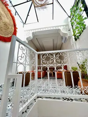 a white staircase with chairs on it at Dar Salomi in Marrakech