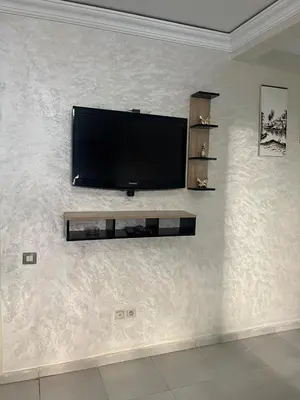 a flat screen tv hanging on a wall at appartement sadaa in Marrakech