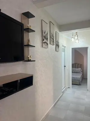 a living room with a flat screen tv on a wall at appartement sadaa in Marrakech