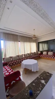 a living room with a couch and a table at VILLA MARRAKECH - Centre Ville in Marrakech