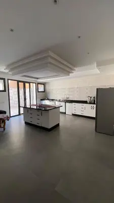 a large kitchen with white appliances in a large room at VILLA MARRAKECH - Centre Ville in Marrakech