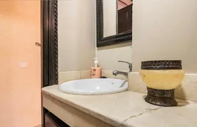 a bathroom counter with a sink and a mirror at Résidence riad jawhara in Marrakech