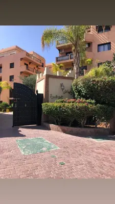 a brick walkway with a gate in front of a building at Résidence riad jawhara in Marrakech