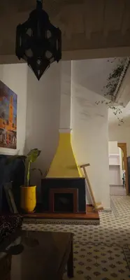 a living room with a couch and a fireplace at Antaki retreat Marrakech in Marrakech